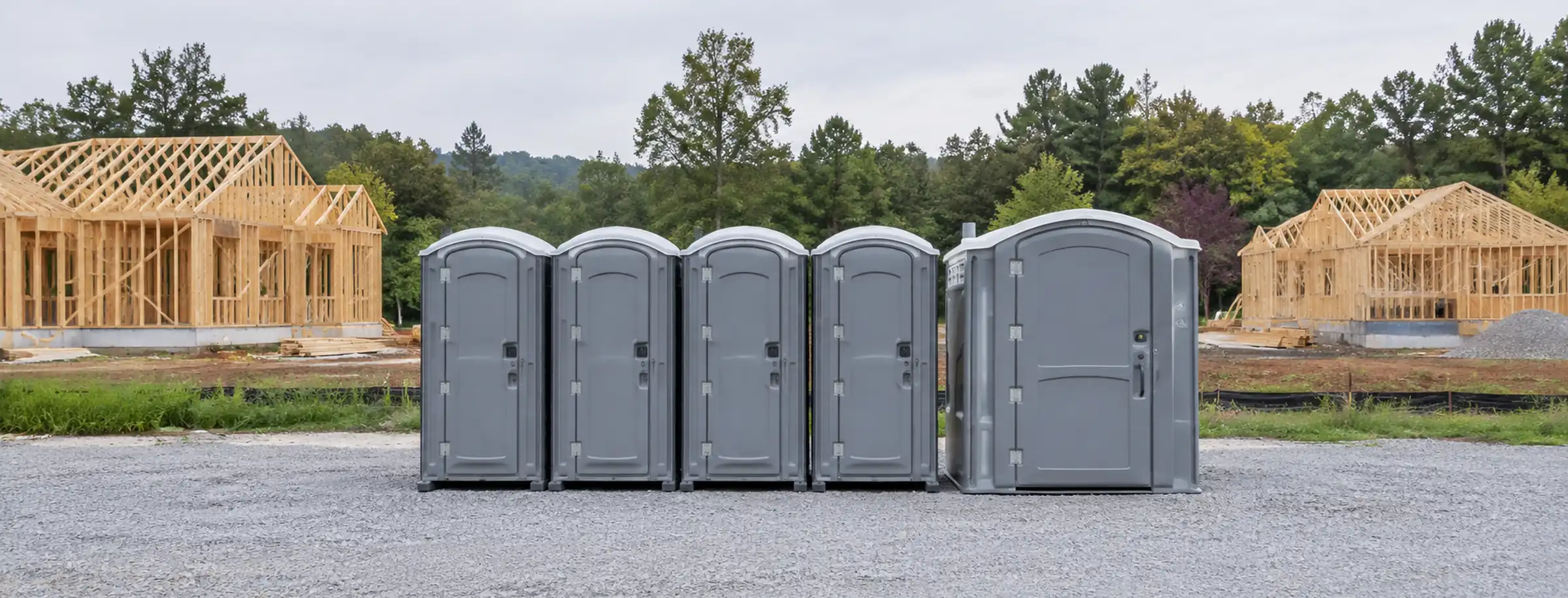 Illustrative row of portable restrooms beside a Central Virginia construction site